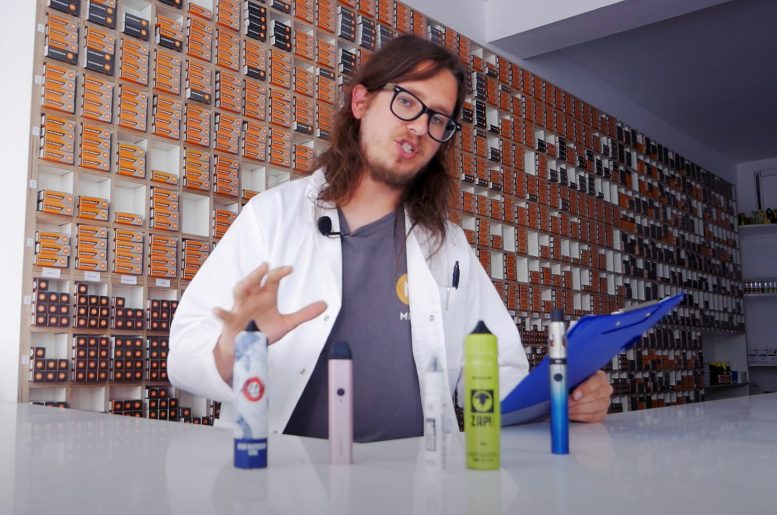 A person showing different bottles of nic salts.