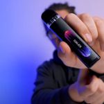 A photo of a man holding a vape pod kit