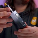 A person holding a vape starter kit