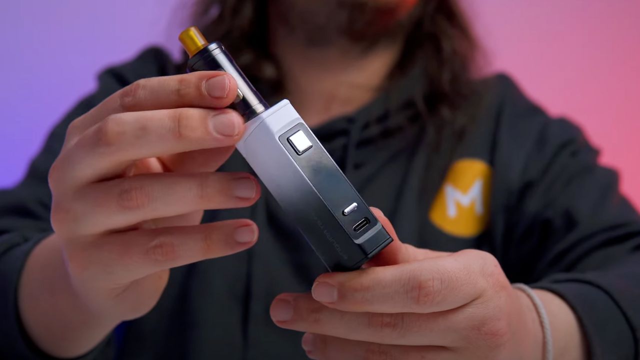 A person holding a vape starter kit