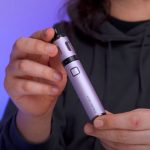 A person showing off the shape of a vape pen.