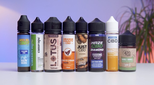 Different CBD e-liquids on a table