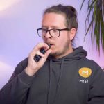 A person vaping with a burnt coil