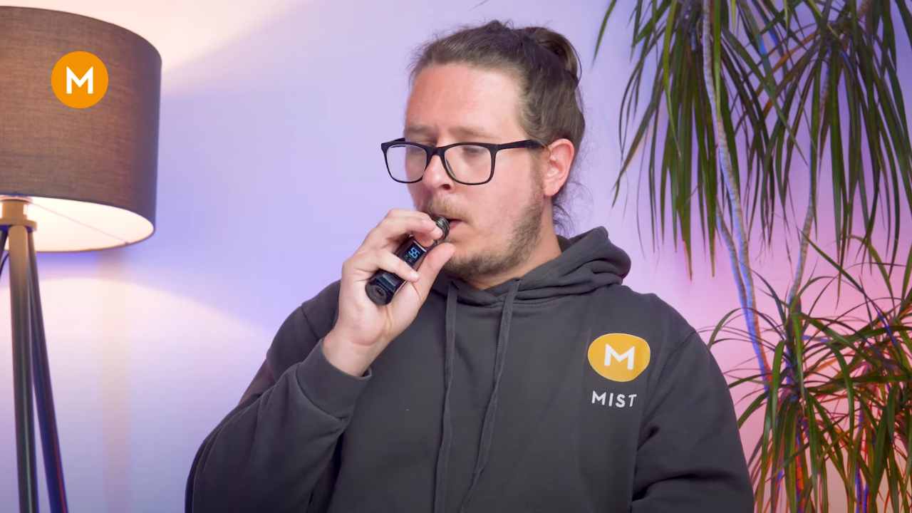 A person vaping with a burnt coil