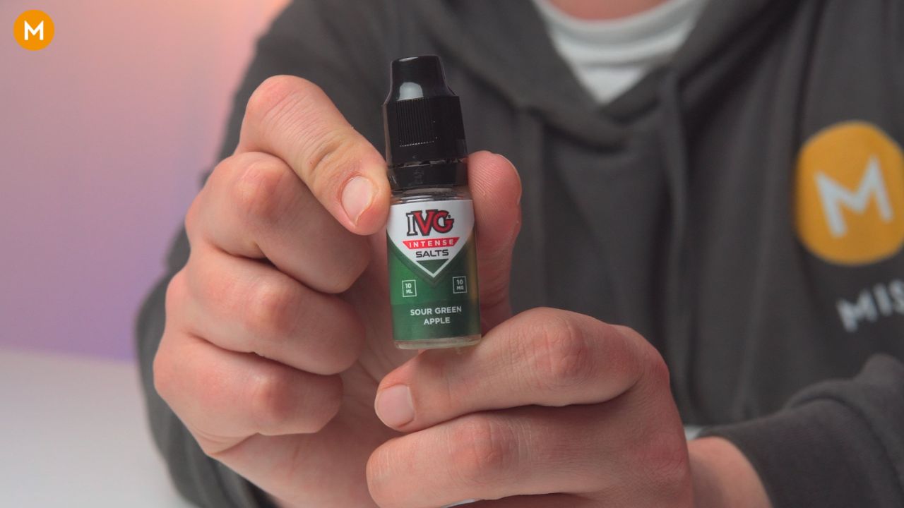 Aiden holding a bottle of IVG Intense Salts sour green apple