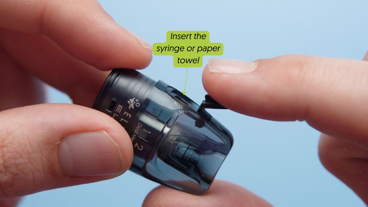 Photo showing where to insert the syringe or paper towel to get vape juice out of the pod vape