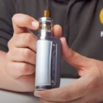 Aiden from MIST holding an Innokin Coolfire Z80 NEX vape for a review