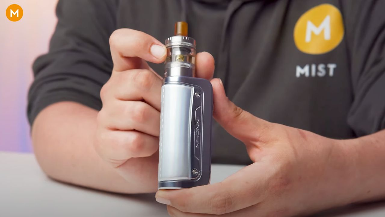 Aiden from MIST holding an Innokin Coolfire Z80 NEX vape for a review